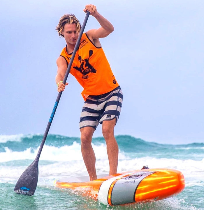 athlete using the carbon paddle in the ocean on an inflatable SUP paddle