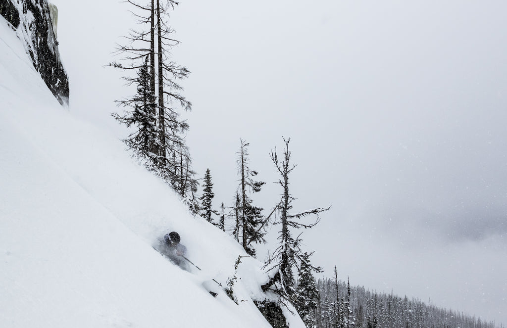 A man skis deep powder on a stormy day at Whistler Blackcomb Ski Resort in British Columbia.